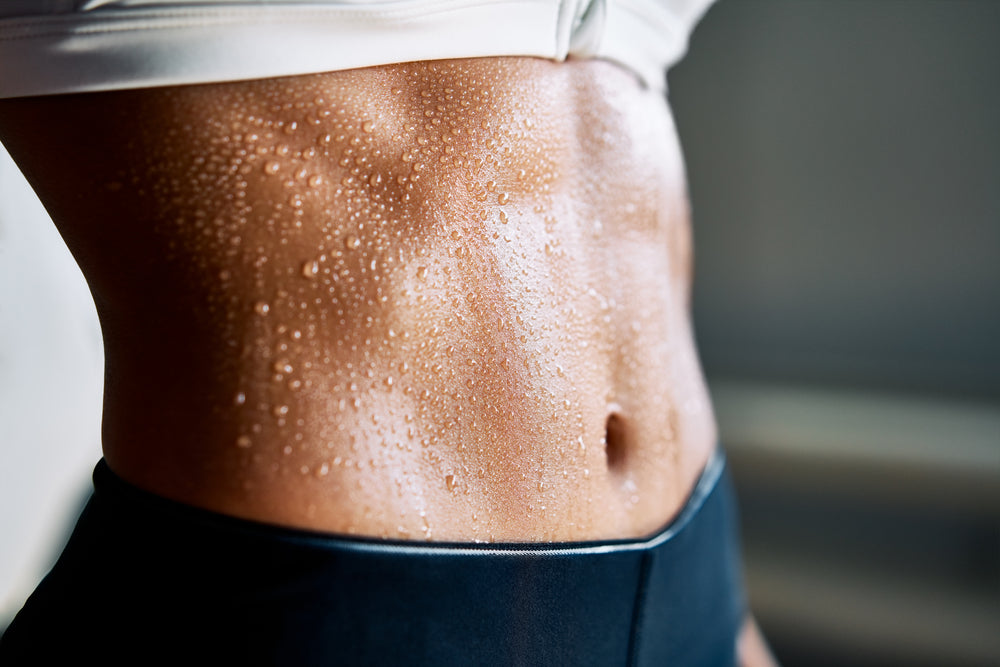 Athletic woman's abdomen sweating Thermogenic cream Intenergy