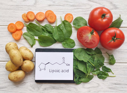 Vegetables next to a tablet with Lipoic-Acid screen